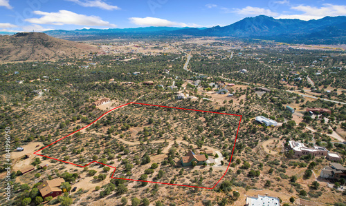 Vacant Land With Mountain Views And Survey Markers In Open Desert Beneath Tranquil Blue Sky