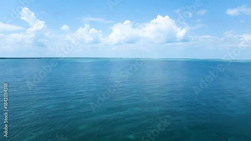 Wallpaper Mural Turquoise ocean water with white clouds a serene seascape of bahamas with bright sun light gleaming in tranquil blue sea at clear sky in daytime Torontodigital.ca