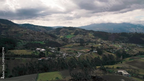 The Otavalo city and valley, showcasing the famous indigenous market, colorful town, and the majestic Imbabura volcano and San Pablo Lake in the Ecuadorian Andes.