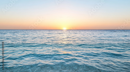 Fototapeta Naklejka Na Ścianę i Meble -  Sunrise ocean horizon calm sea gentle waves glowing sky