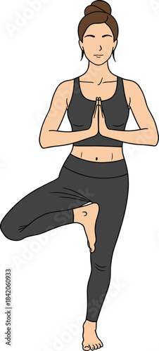 Woman in yoga tree pose with hands in prayer position and eyes closed vrikshasana