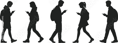 Silhouettes of distracted young people walking while focused intently on their mobile phones, symbolizing modern digital connection, technology, and addiction.