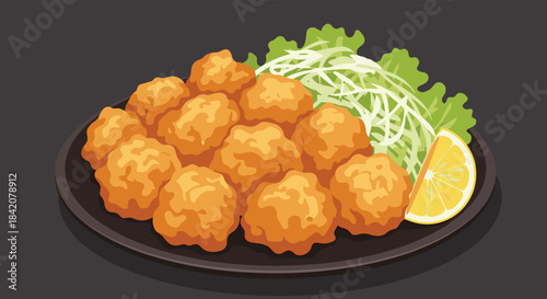 Delicious plate of Japanese fried chicken karaage served with shredded cabbage salad and a fresh lemon wedge on a dark plate.