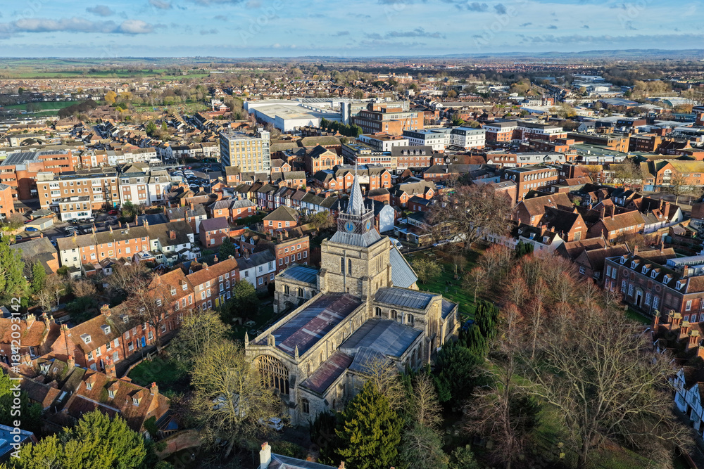Fototapeta premium Aerial drone photography of the centre of Aylesbury town in Buckinghamshire, England. Featuring a church which is perched on top of a hill in the town centre and overlooks the surrounding Chilterns
