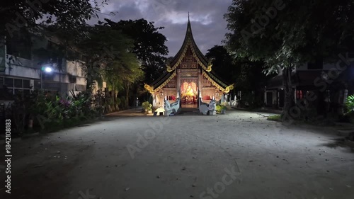Walking towards Wat Pan Sao Buddhist temple at night in Chiang Mai, Thailand
