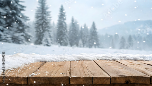A weathered wooden table in a snowy landscape with distant pine trees and falling snowflakes