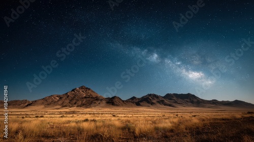Vast desert landscape under a brilliant starry night sky and the milky way