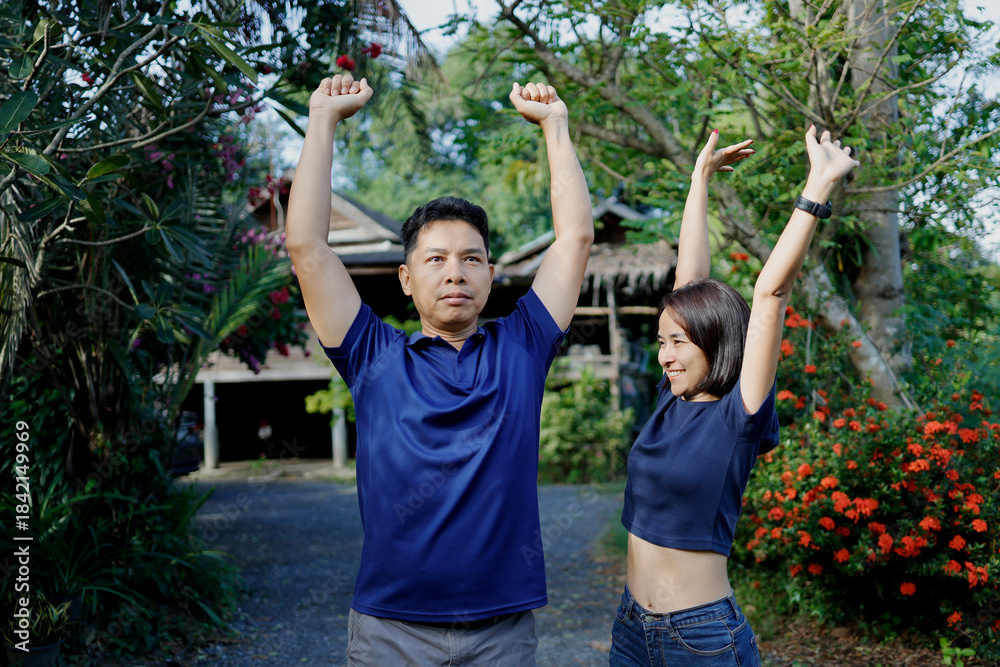 Fototapeta premium Woman and man stretches before exercising in the morning.