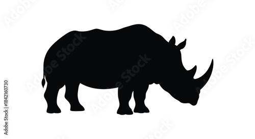 A striking black rhinoceros form depicted in a detailed and imposing animal silhouette