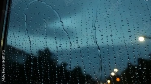 Rainwater Droplets Trickling Down a Glass Window – Moody Weather Scene