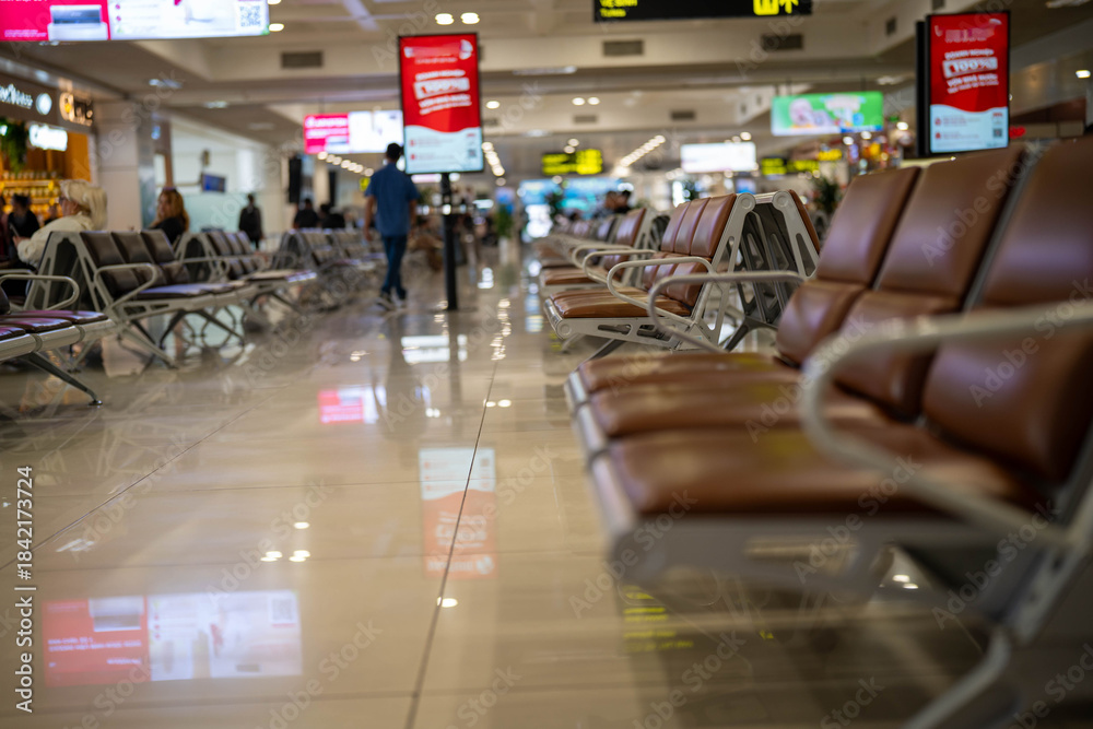 Obraz premium Quiet airport waiting area with empty seating and soft lighting.