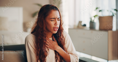 Foto Sick, woman and chest pain with pressure on sofa from heart attack, angina and medical crisis