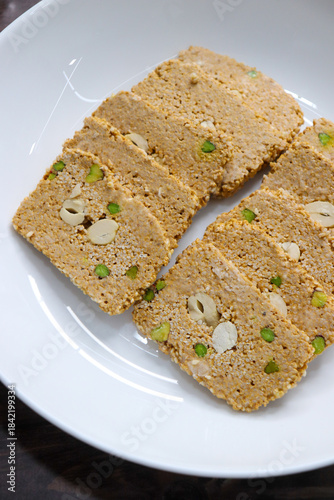 Til gajak, a traditional Indian winter sweet made with sesame seeds, jaggery, ghee, and dryfruits. Crunchy til chikki festive treat for Makar Sankranti. Tilgul. sesame candy. Copy Space. Winter food.