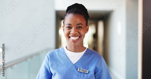 Happy, black woman and portrait of nurse in hospital for support, medical service or about us. Smile, professional and African female healthcare worker with confidence for nursing career in clinic.