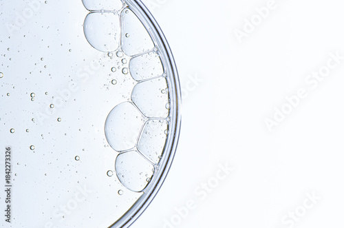 Cosmetic moisturizing gel or skin serum in a petri dish. Copy space