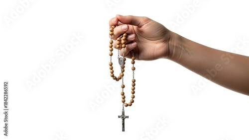 Hand holds a brown beaded rosary with a silver cross on a white background