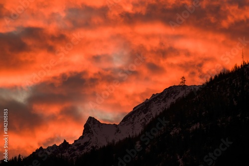 beautiful orange sky over the mountains in Austria at a winter morning