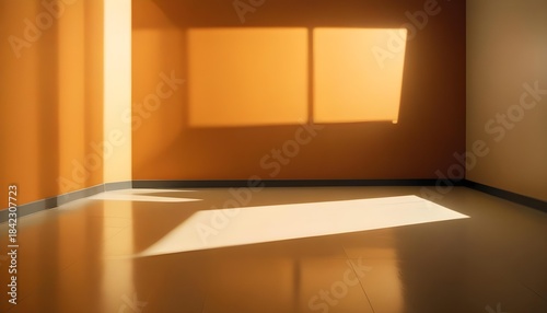 Empty room with warm orange walls and sunlight streaming through windows