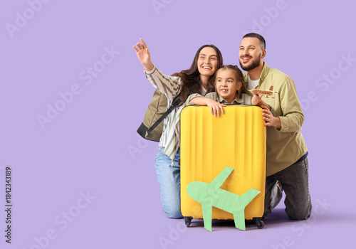 Family of travelers with su...