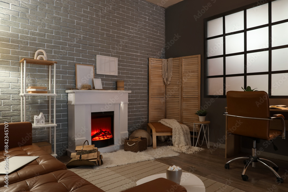 Obraz premium Interior of living room with fireplace, folding screen and workplace