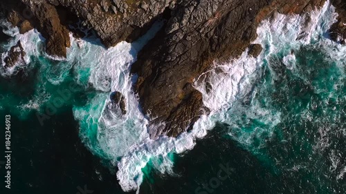 Rocky Shores And Densely Forested Mountain. Aerial Pullback Shot