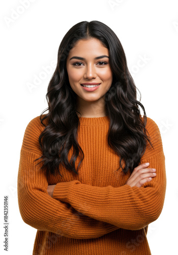 beautiful young hispanic woman in oversized orange knit sweater, arms crossed, warm smile, isolated against white studio background under high-key light. concept of youthful confidence