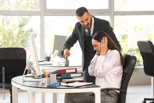 Angry male boss shouting at...