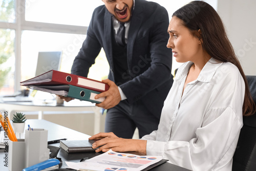 Angry male boss with folder...