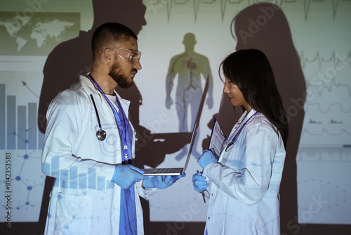 Young doctors with laptop a...