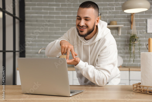 Young man with laptop using...