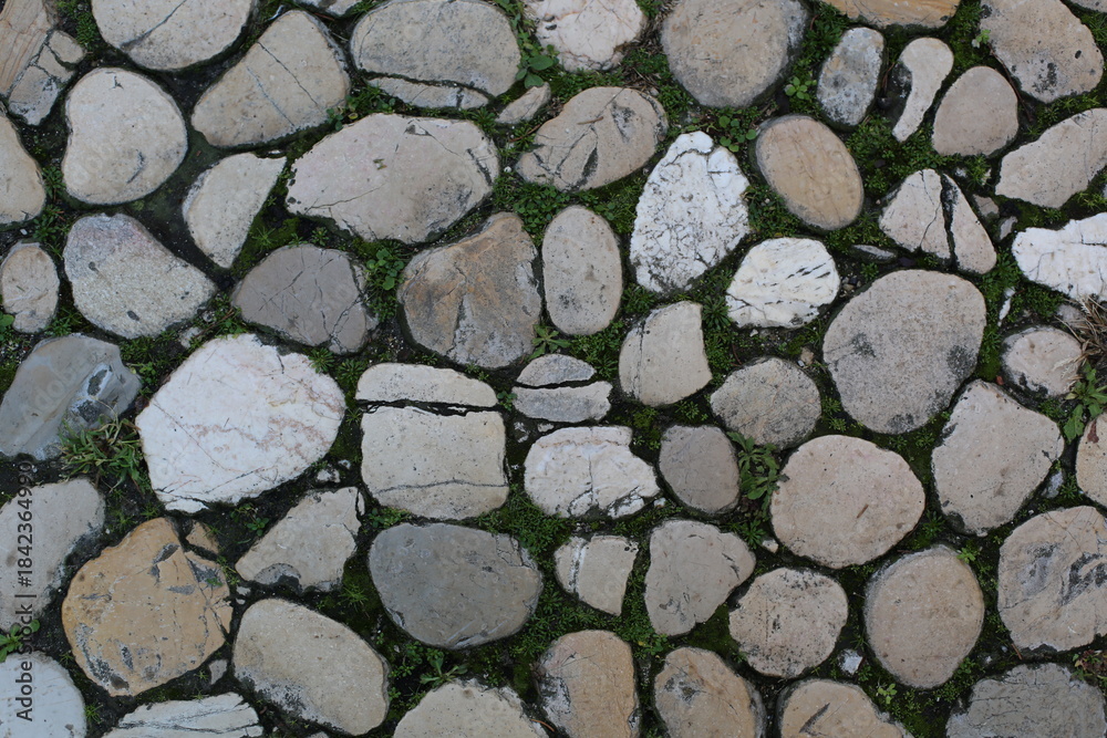 Fototapeta premium old stone wall background on the road