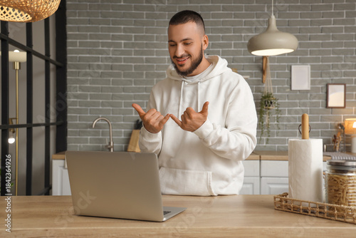 Young man with laptop using...