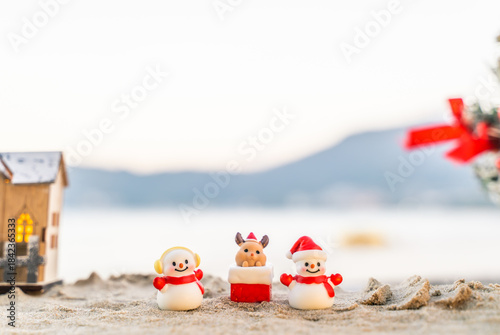 Santa Claus Doll Cute and Christmas Tree House Relaxing on the Beach. Merry Christmas Holiday. Bright Background. Patong Beach, Phuket, Thailand.