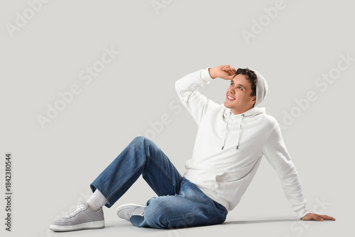 Young man in white hoodie s...