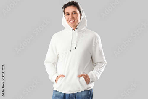 Smiling young man in white ...