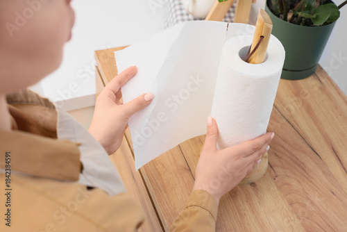 Woman with roll of paper to...