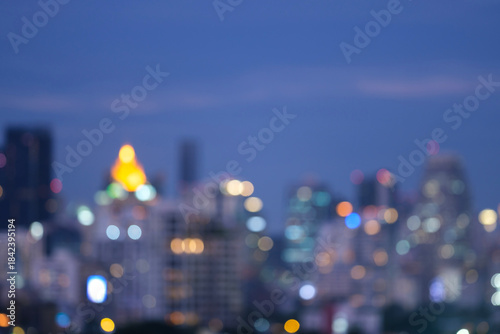 Abstract blurred background cityscape of Krung Thep Maha Nakhon (Bangkok) on night scene with multicolour bokeh from neon light on building