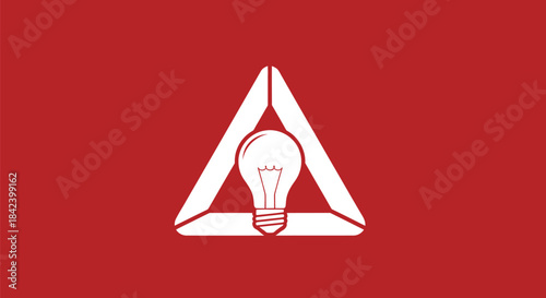 A bright white lightbulb encased in a white triangular structure set against a red background