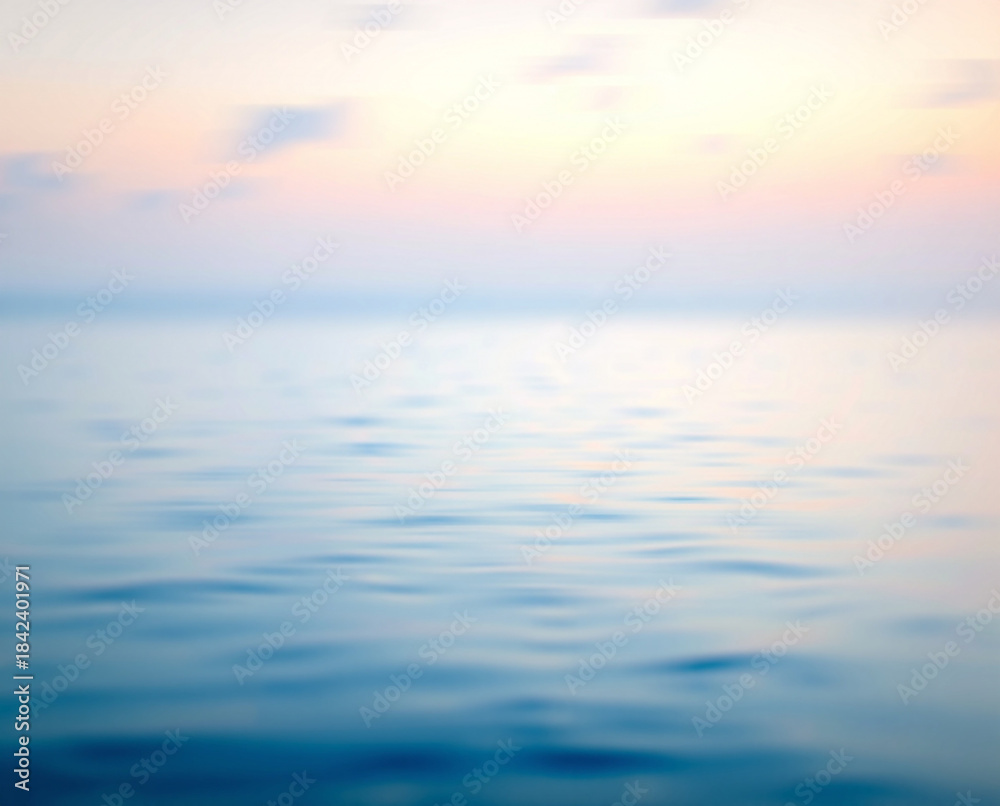 Obraz premium Title: A blurred of a calm ocean with soft pink and blue hues during sunset