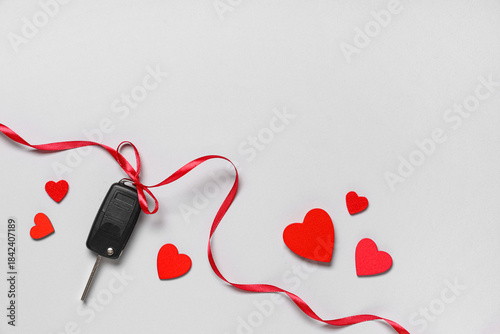 Car key with red bow and he...