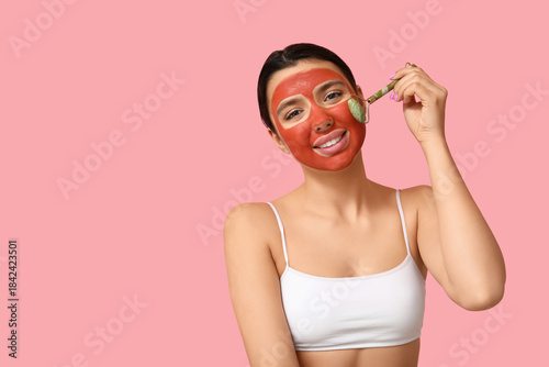Young woman with facial mas...