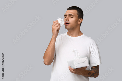 Ill young man with tissues ...