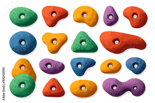 Colorful climbing holds arranged on a white surface for indoor rock climbing practice sessions in a training facility