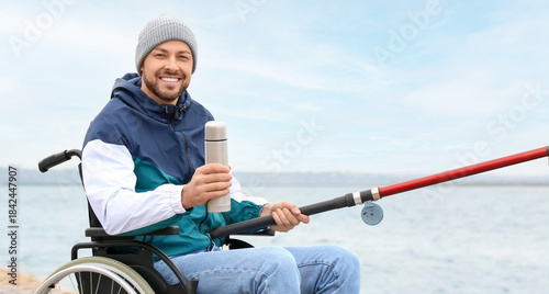 Man in wheelchair drinking ...