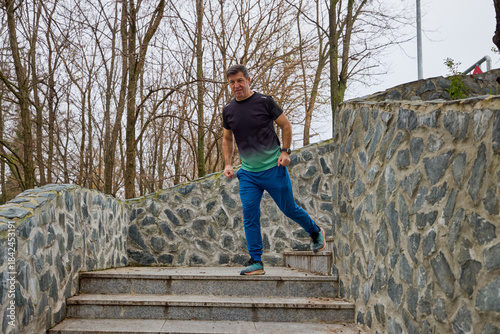 A middle-aged man does morning warm-up exercises and runs.