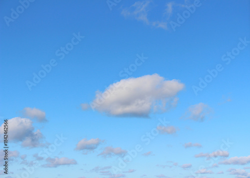 Blue sky with white clouds. Fluffy cumulus formations. Clear weather and sunshine. Blue sky with white clouds with selective focus. Blue sky with some clouds.