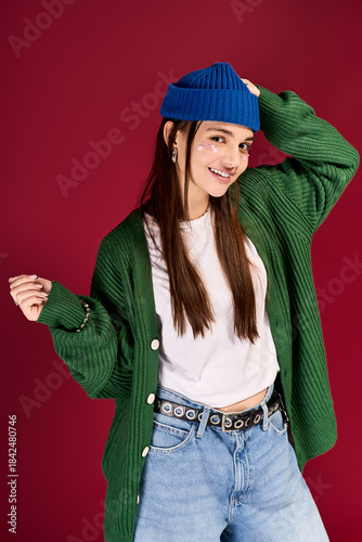Stunning teenage girl radiates style with blue beanie in trendy winter outfit