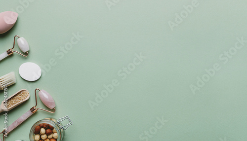 Skincare Essentials Jade Roller, Makeup Sponge, and Beauty Tools on a Mint Green Background