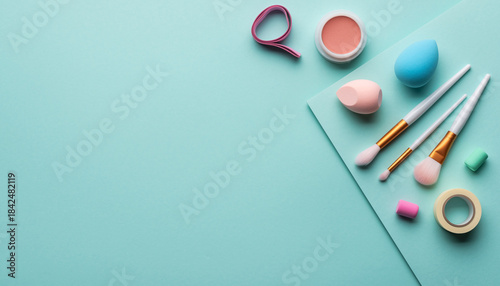 Cosmetics and Makeup Tools A Vibrant Flat Lay Composition on a Light Blue Background