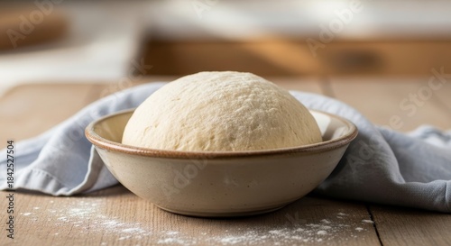 Golden sphere of homemade dough resting gracefully in a rustic ceramic bowl ready for baking